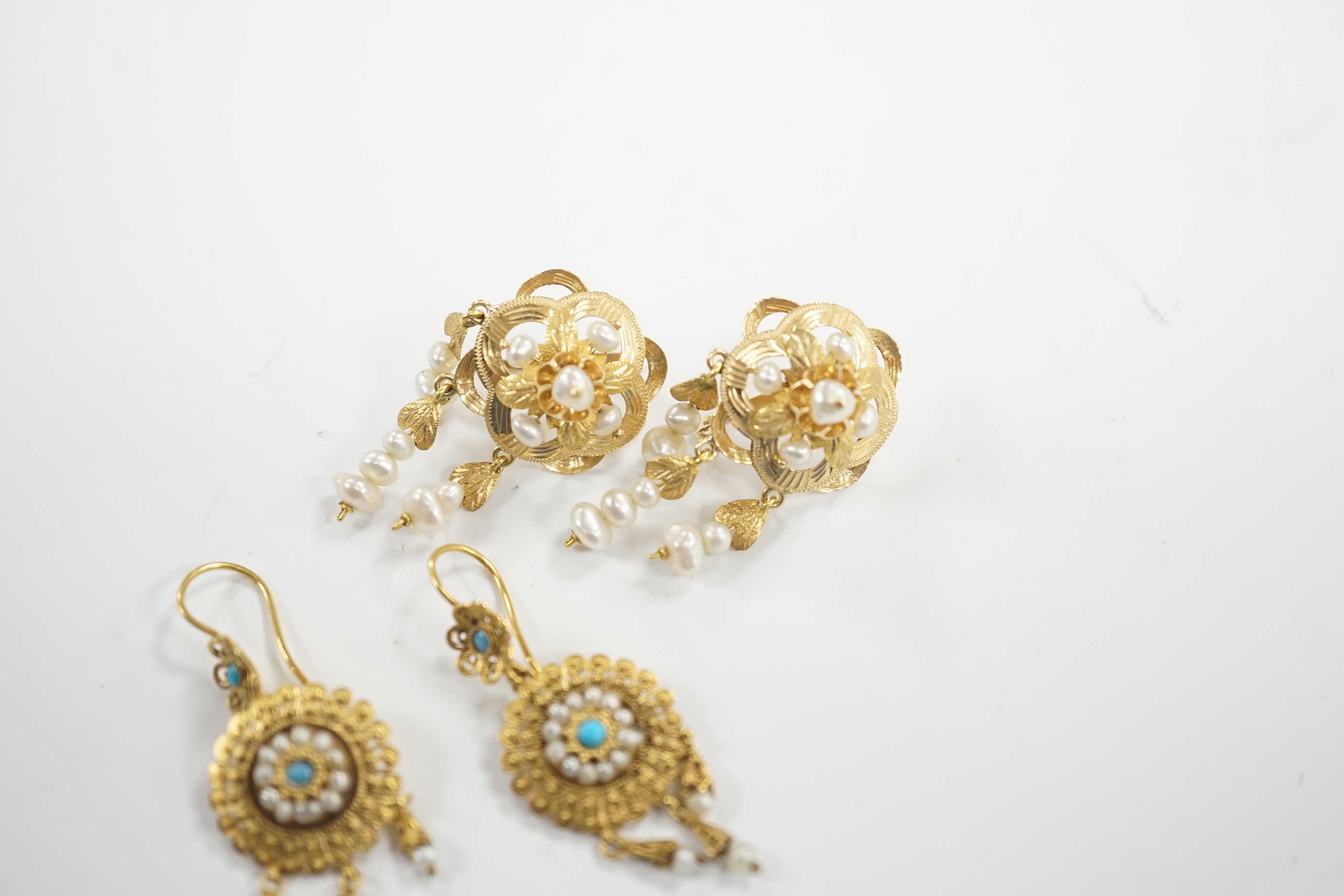 A pair of continental yellow metal and cultured pearl cluster set drop earrings, 36mm and a pair of yellow metal filigree, seed pearl and turquoise set drop earrings, gross weight 10.9 grams.